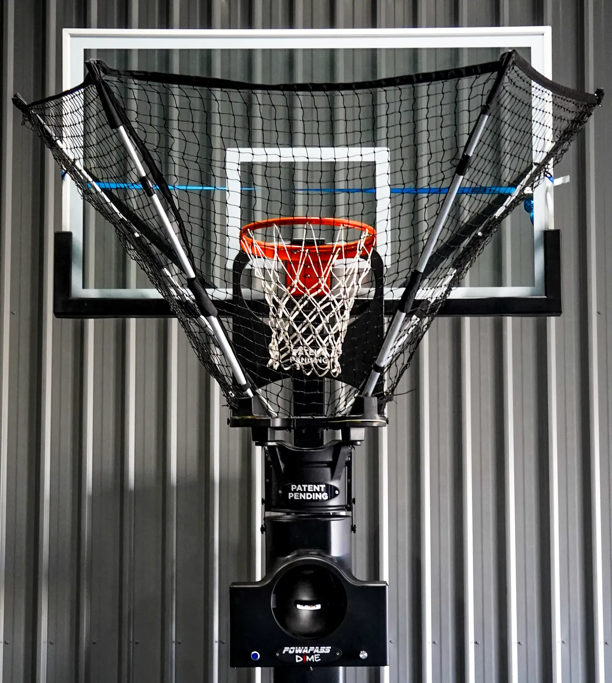 TMG Assist basketball training machine mounted on a ring with its catch net open